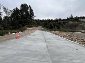 A road with orange cones on it

AI-generated content may be incorrect.